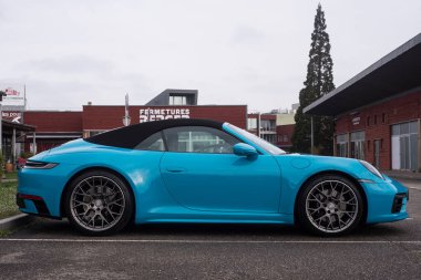 Lutterbach - Fransa - 3 Nisan 2022 - Mavi Porsche 911 Carrera 4S 'nin profil görüntüsü caddeye park edilmiş 