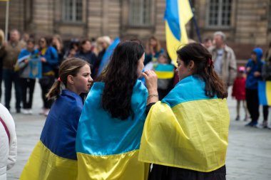 Strasbourg - France - 24 April 2022 - Portrait on back view of woman with ukrainian flag against the war 