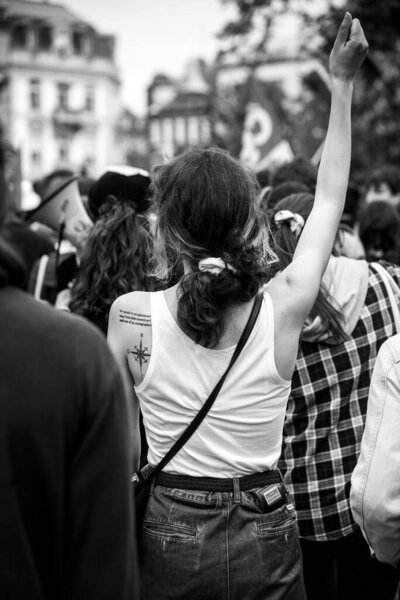 Strasbourg - France - 24 April 2022 - Portrait on back view of antifascist  girl protesting in the street  