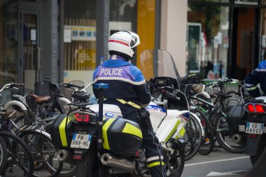 Strasbourg - France - 30 April 2022 - Portrait of french national policeman and motorbike in the street 
