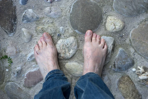 Closeup Barefoot Man Pebblestone Surface Outdoor — стоковое фото