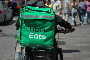 Strasbourg - France - 14 May 2022 - Portrait of uber eats delivery man in bicycle waiting in the street 