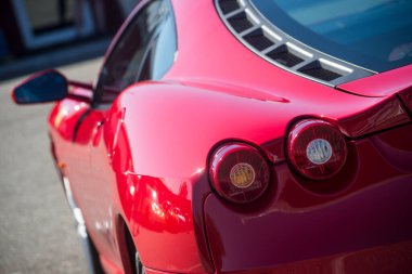 Lutterbach - France - 4 July 2022 - closeup of rear light of red ferrari F430 parked in the street