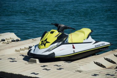 Valras - France - 26 July 2022 - Closeup of yellow jet ski parked in border the sea