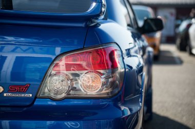 Lutterbach - France - 7 August 2022 - closeup of rear light of blue Subaru impreza parked in the street  