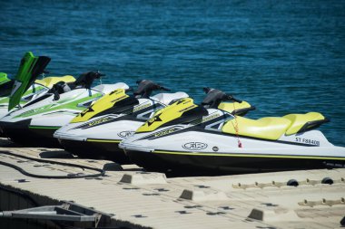 Valras - France - 26 July 2022 - Closeup of yellow jet ski alignment parked in border the sea