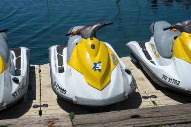 Le cap d'agde - France - 27 July 2022 - Closeup of yellow and white  jet ski alignment parked in border the sea
