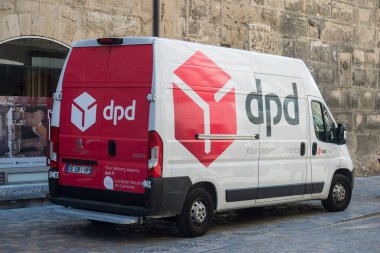 Narbonne - France - 28 July 2022 - Profile view of dpd logo on delivery truck by mercedes parked in the street 