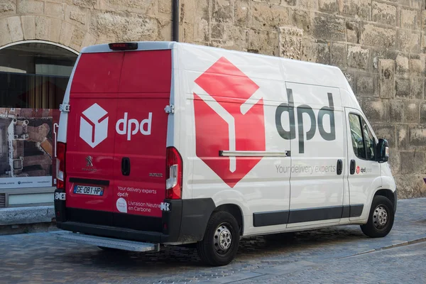 Narbonne - France - 28 July 2022 - Profile view of dpd logo on delivery truck by mercedes parked in the street 