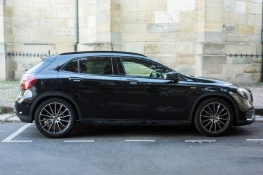 Mulhouse - France - 21 August 2022 - Profile view of black Mercedes GLA220 d SUV parked in the street 