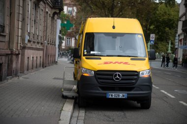 Strasbourg - Fransa - 17 Eylül 2022 - Sokakta park halindeki sarı DHL dağıtım kamyonunun ön görüntüsü