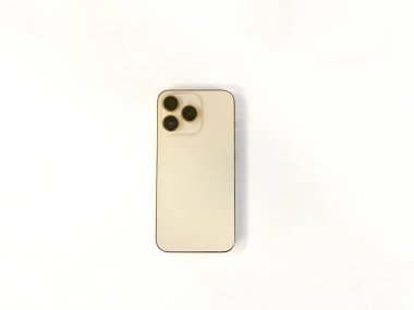 Beyaz izole edilmiş arka planda üç kameralı modern altın renkli telefon.