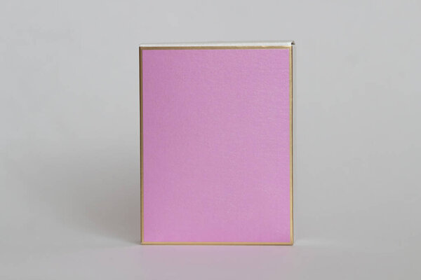 Perfume bottle from a pink box on a white isolated background