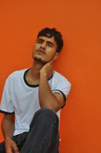 Good Looking Indian Young Guy Looking Sideways While Sitting Posing — Stockfoto