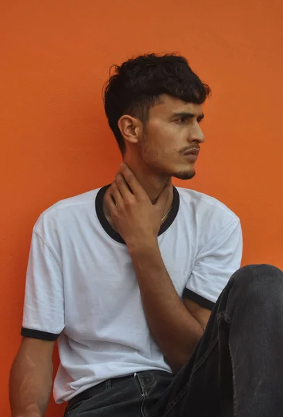 Good Looking Indian Young Guy Looking Sideways While Sitting Posing — стокове фото