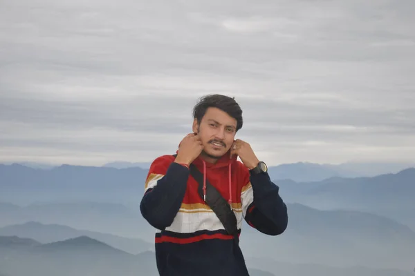 Young Guy Looking Camera Adjusting Collar While Standing Background Mountains — Stockfoto