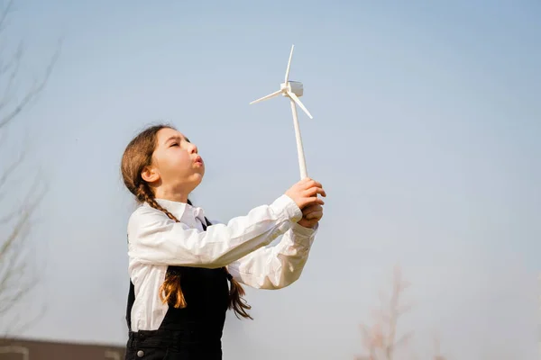 Closeup Little Girl Blowing Wind Turbine Toy Studying How Green — Stock fotografie