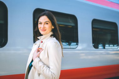Portrait of a business woman commuter walking in a train station or airport going to boarding gate with hand luggage