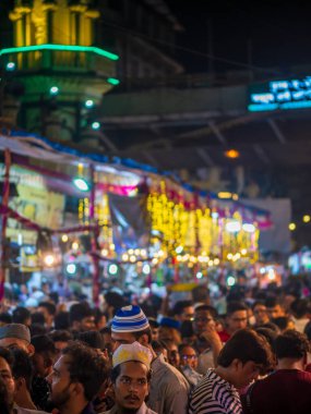 Mumbai, India - May 1, 2022 : Crowd gathered to tests Ramzan or Ramadan feast at night market.Vertical or portrait orientation