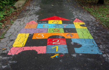 Colourful Hopscotch game for children painted on the pavement in the park. Hopscotch game in the shape of the castle.