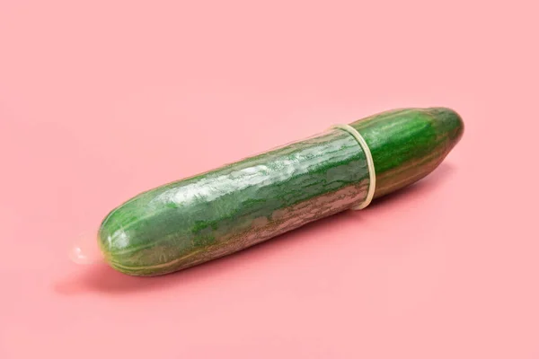 Condom Stretched Cucumber Lies Pink Background — Stock Photo, Image