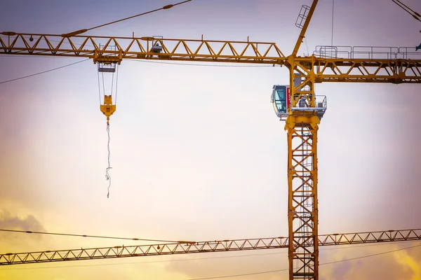 Construction site with cranes, retro tone image — Stock Photo, Image