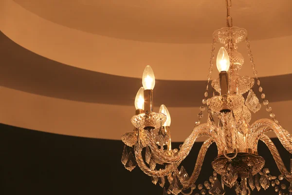 Luksusowy kryształowy żyrandol na tle ciemnej ściany — Zdjęcie stockowe
