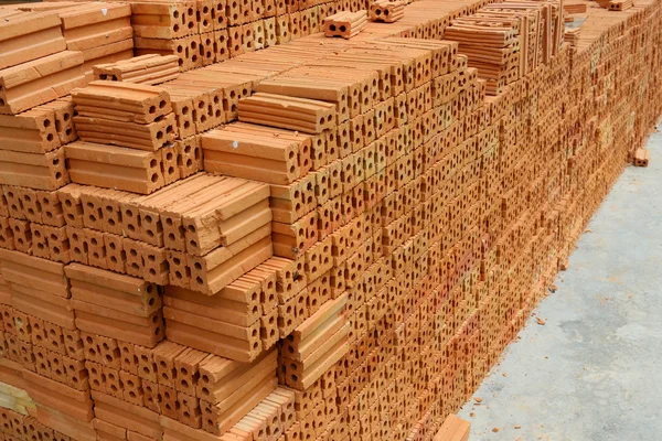 Stack of red bricks, bricks used for building construction — Stock Photo, Image