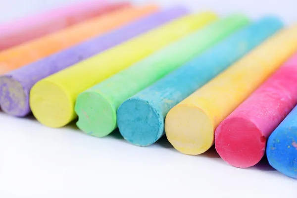 Closeup colored chalk arranged on a white background, chalk isol — Stock Photo, Image