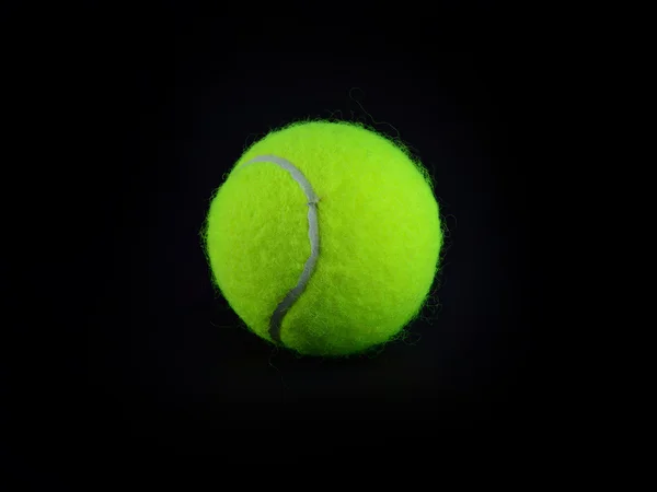 Één tennisbal op zwarte achtergrond — Stockfoto