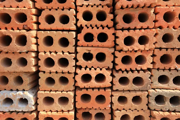 Stack of red bricks, bricks used for building construction — Stock Photo, Image