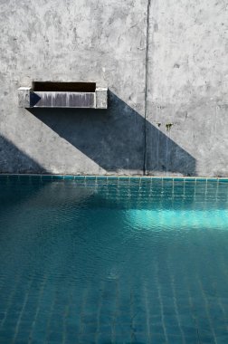 faucet of swimming pool on cement wall, construction industry