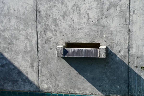 faucet of pool on cement wall background