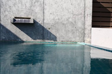 faucet of swimming pool on cement wall, construction industry