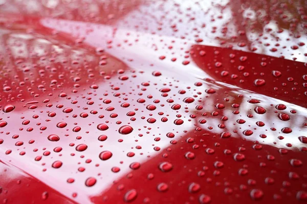 water on red hood car, transportation background