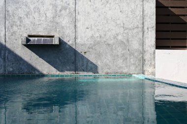 faucet of swimming pool on cement wall, construction industry