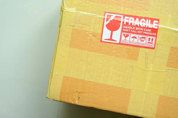 brown box packaging with warning symbol