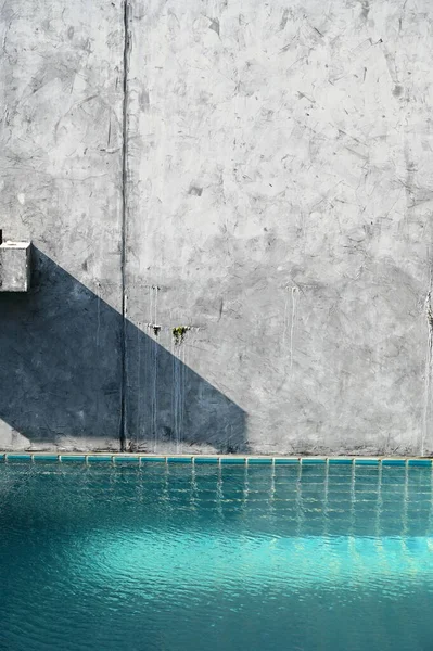 blue swimming pool and cement wall, construction industry