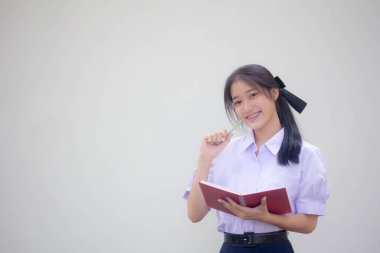 Asya Thai Lisesi üniformalı güzel kız. Bir kitap yaz.