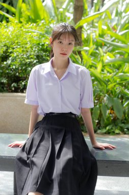 Asya thai lise öğrencisi üniforması güzel kız gülümse ve rahatla