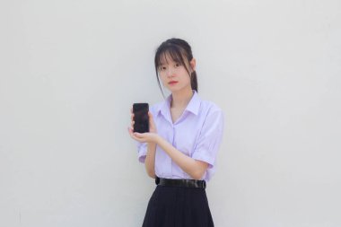 asia thai high school student uniform beautiful girl show her phone and smile