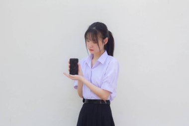 asia thai high school student uniform beautiful girl show her phone and smile