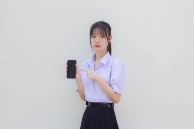 asia thai high school student uniform beautiful girl show her phone and smile