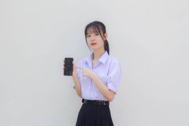 asia thai high school student uniform beautiful girl show her phone and smile