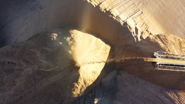 소금 구덩이에 있는 컨베이어 가염분을 추출하여 모래를 무더기 속으로 쏟아 붓는다. 비어 있는 바위를 쓰레기장으로 옮김. — 비디오