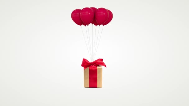 Geschenkschachtel mit Schleife, die an einem Bündel Luftballons befestigt ist, fliegt von unten über weißem Hintergrund mit Alfa-Kanal auf, luma matt. — Stockvideo