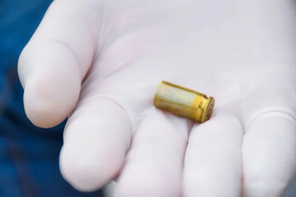 Blur Pistol Bullet Shells Holding White Gloved Fingers — Stock Photo, Image
