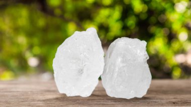 Kristal berrak alum küpleri ya da kahverengi tahta üzerinde potasyum alum. Kimyasal bileşik madde. Güzellik, kaplıca ve koltuk altı tedavi kavramı endüstriyel. 