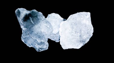 Isolated clear alum cubes on dark background concept for spa and body deodorant industrial