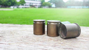 Used copper empty bullet shells on wood plank